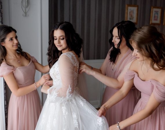 bridesmaids-dressed-pink-dresses-are-helping-bride-prepare-wedding-ceremony-min